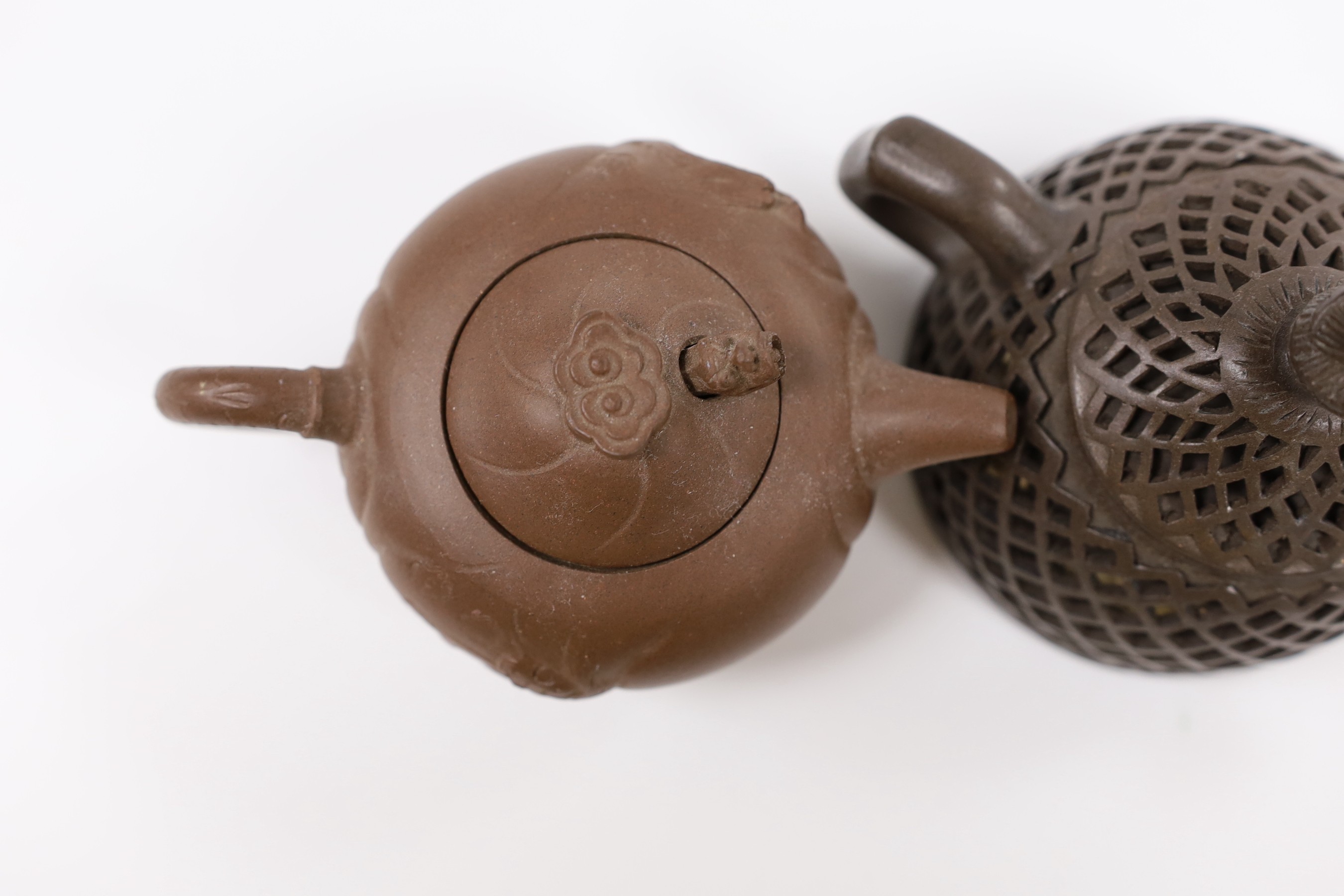 A Chinese Yixing reticulated teapot and cover and another